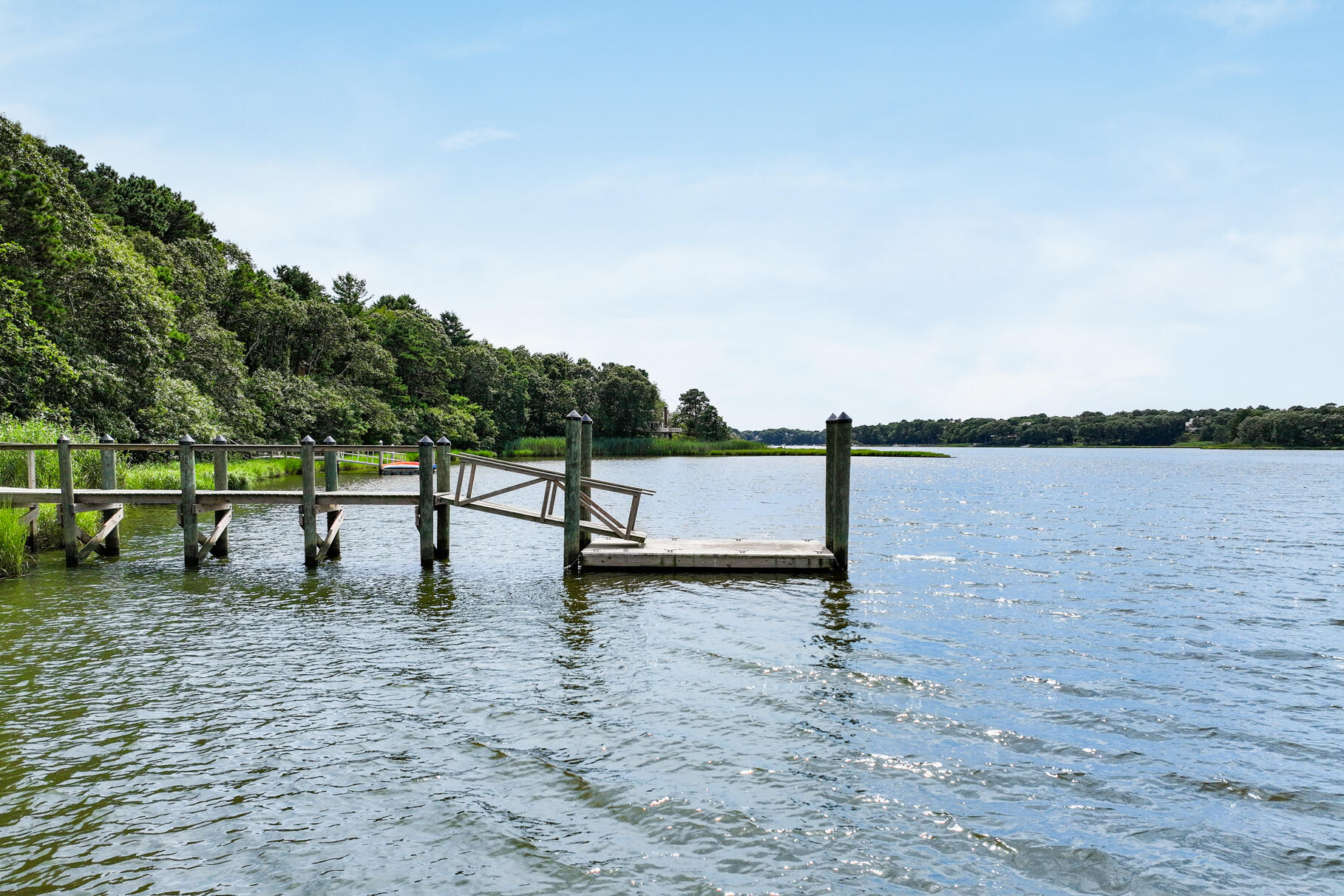 24 Bay Road Cotuit, MA 02635 - Photo 34 of 44 a view of a lake with a yard