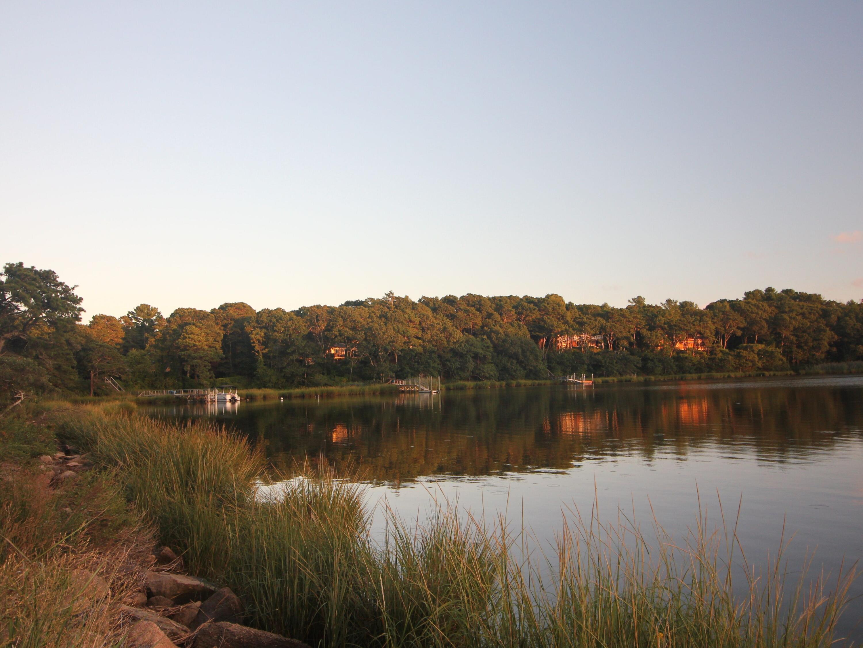 24 Bay Road Cotuit, MA 02635 - Photo 39 of 44 a view of a lake with a mountain in the background