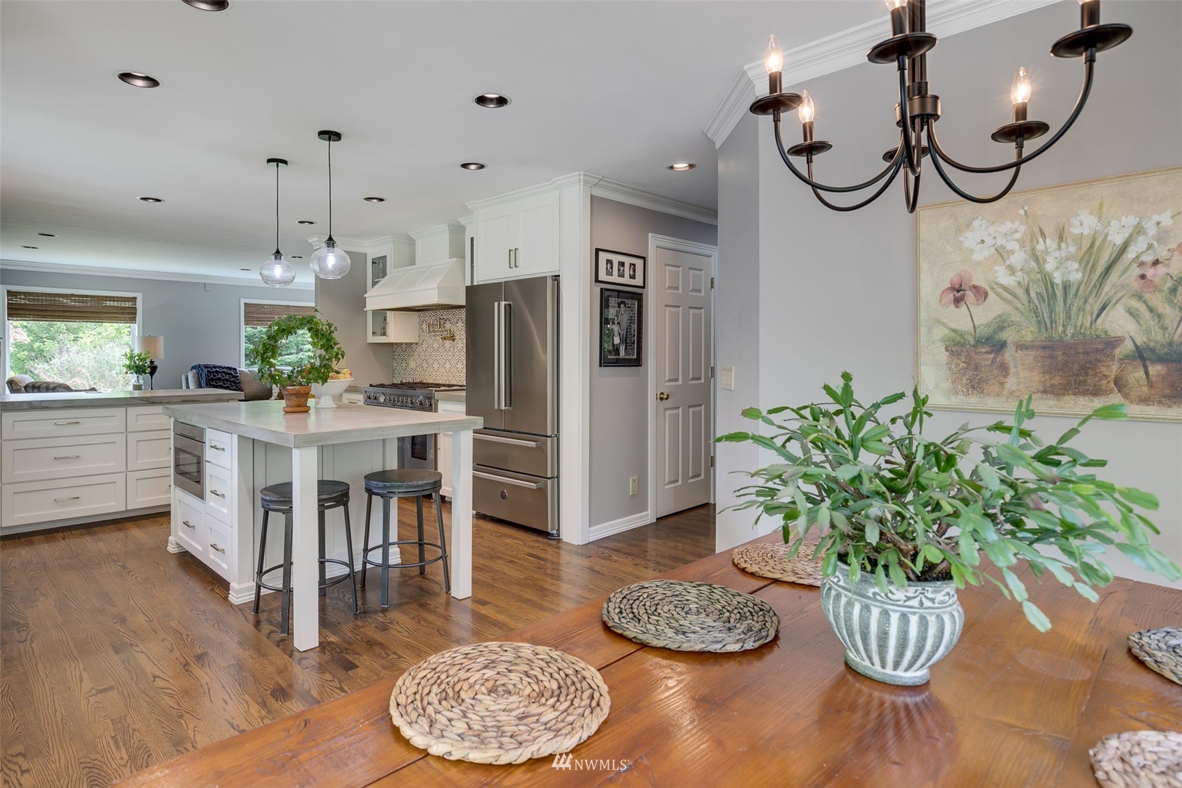 14919 Westwick Road Snohomish, WA 98290 - Photo 15 of 37 a kitchen with stainless steel appliances granite countertop a dining table chairs and a refrigerator