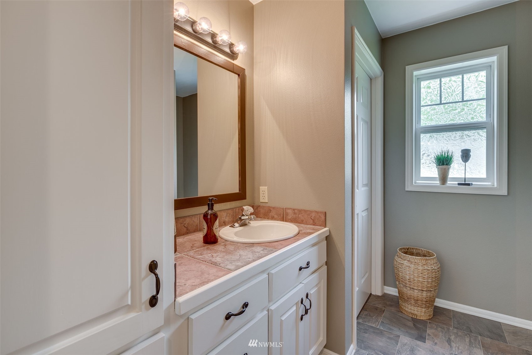14919 Westwick Road Snohomish, WA 98290 - Photo 21 of 37 a bathroom with a granite countertop sink a toilet and a mirror