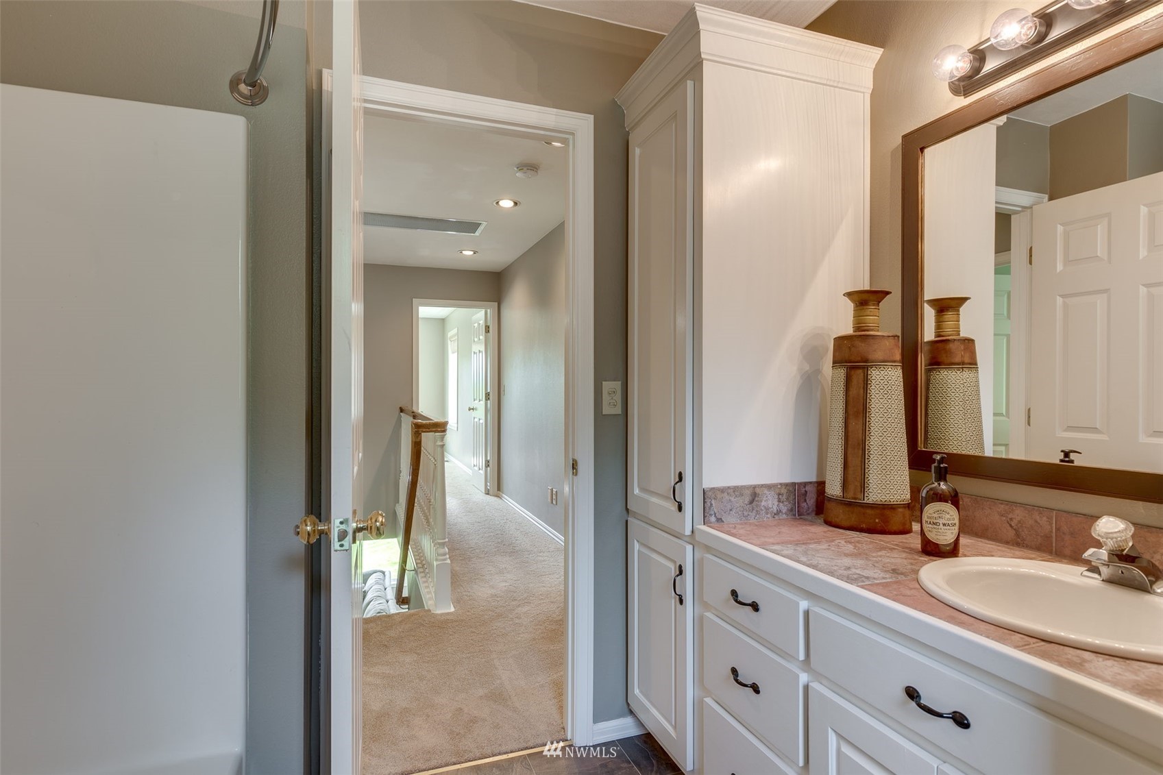 14919 Westwick Road Snohomish, WA 98290 - Photo 22 of 37 a en suite bathroom with a granite countertop sink and a mirror