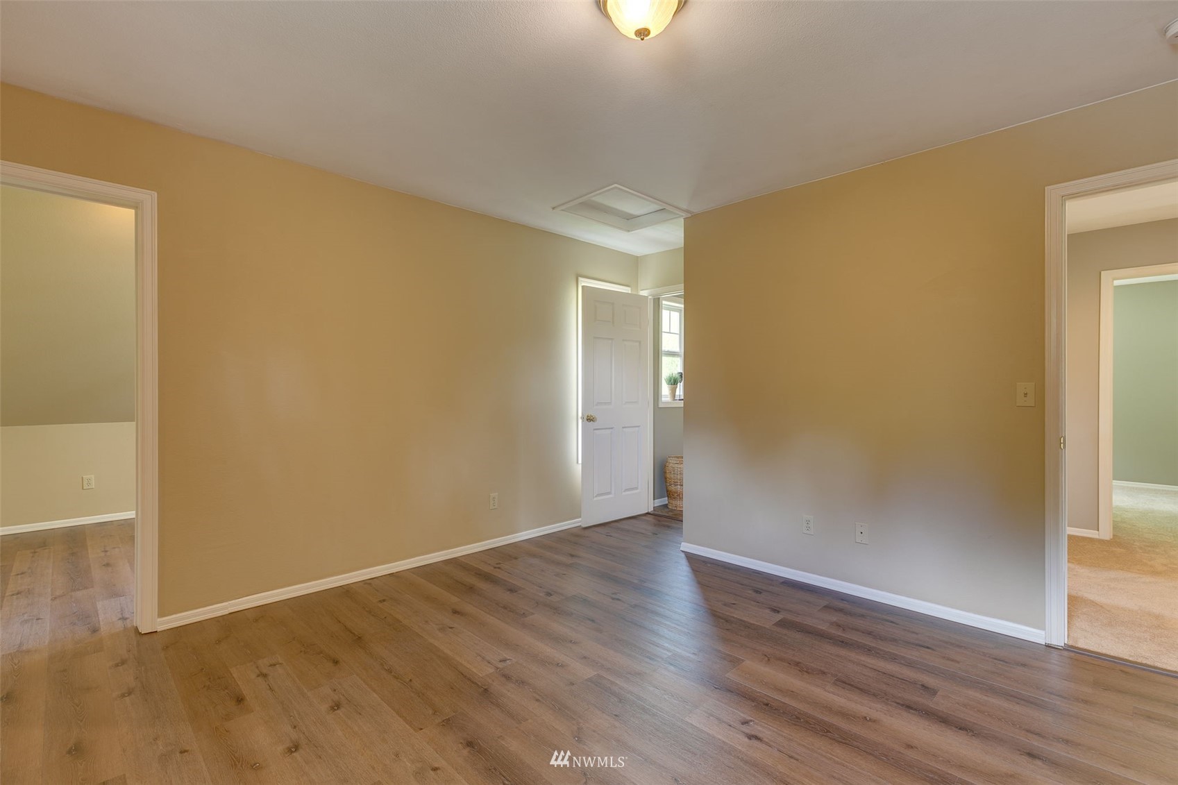14919 Westwick Road Snohomish, WA 98290 - Photo 25 of 37 an empty room with wooden floor and windows