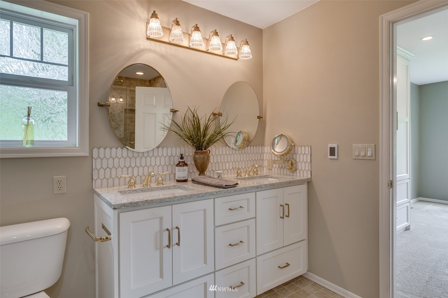 14919 Westwick Road Snohomish, WA 98290 - Photo 30 of 37 a bathroom with a granite countertop sink a toilet and a mirror