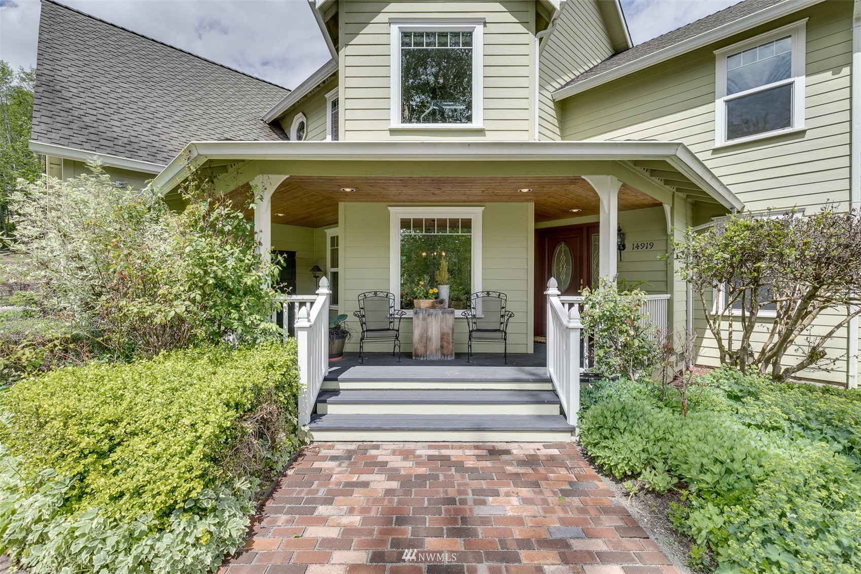14919 Westwick Road Snohomish, WA 98290 - Photo 3 of 37 a view of a house with potted plants and a table and chairs