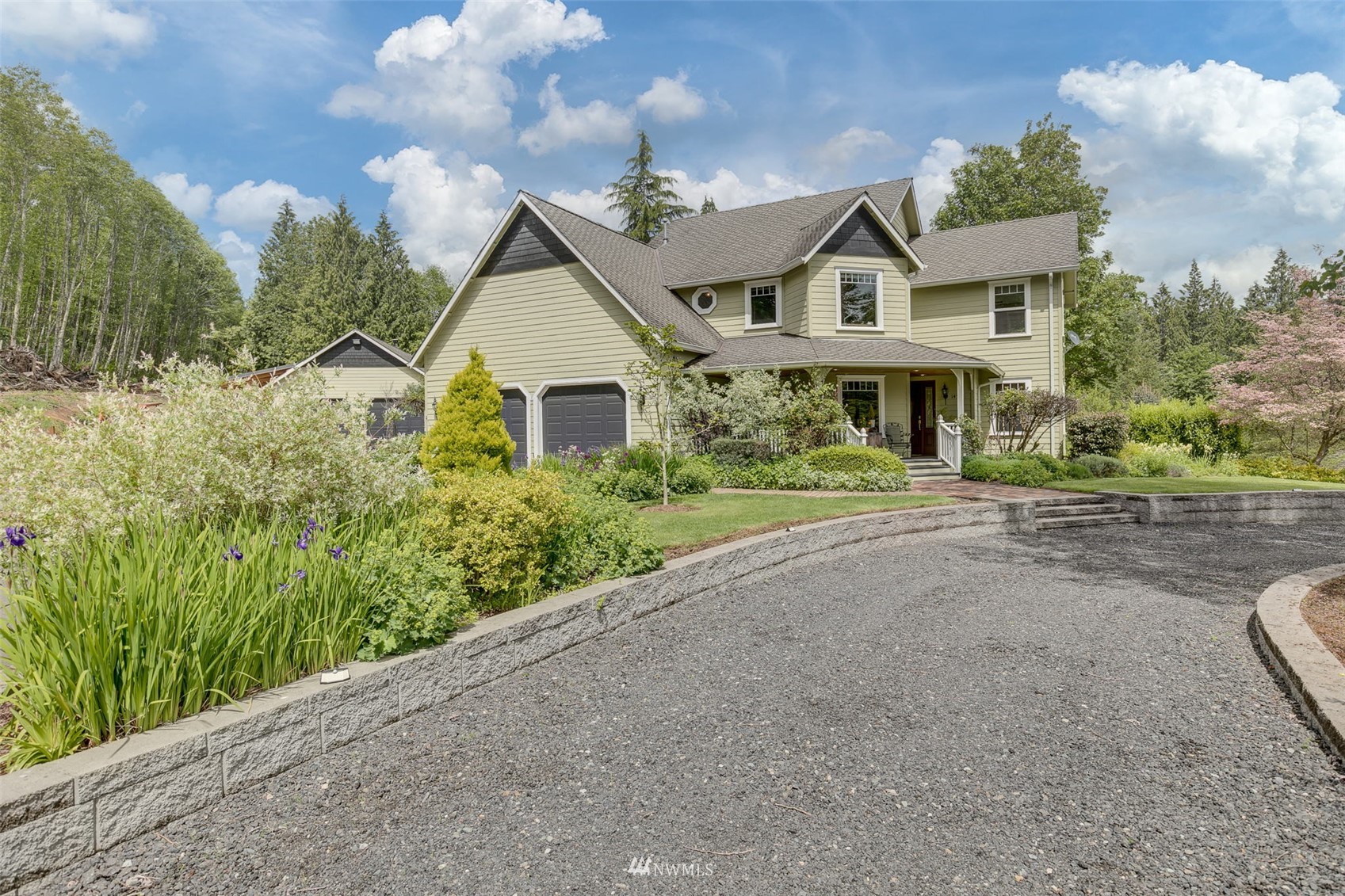 14919 Westwick Road Snohomish, WA 98290 - Photo 34 of 37 a view of a white house with a big yard and potted plants