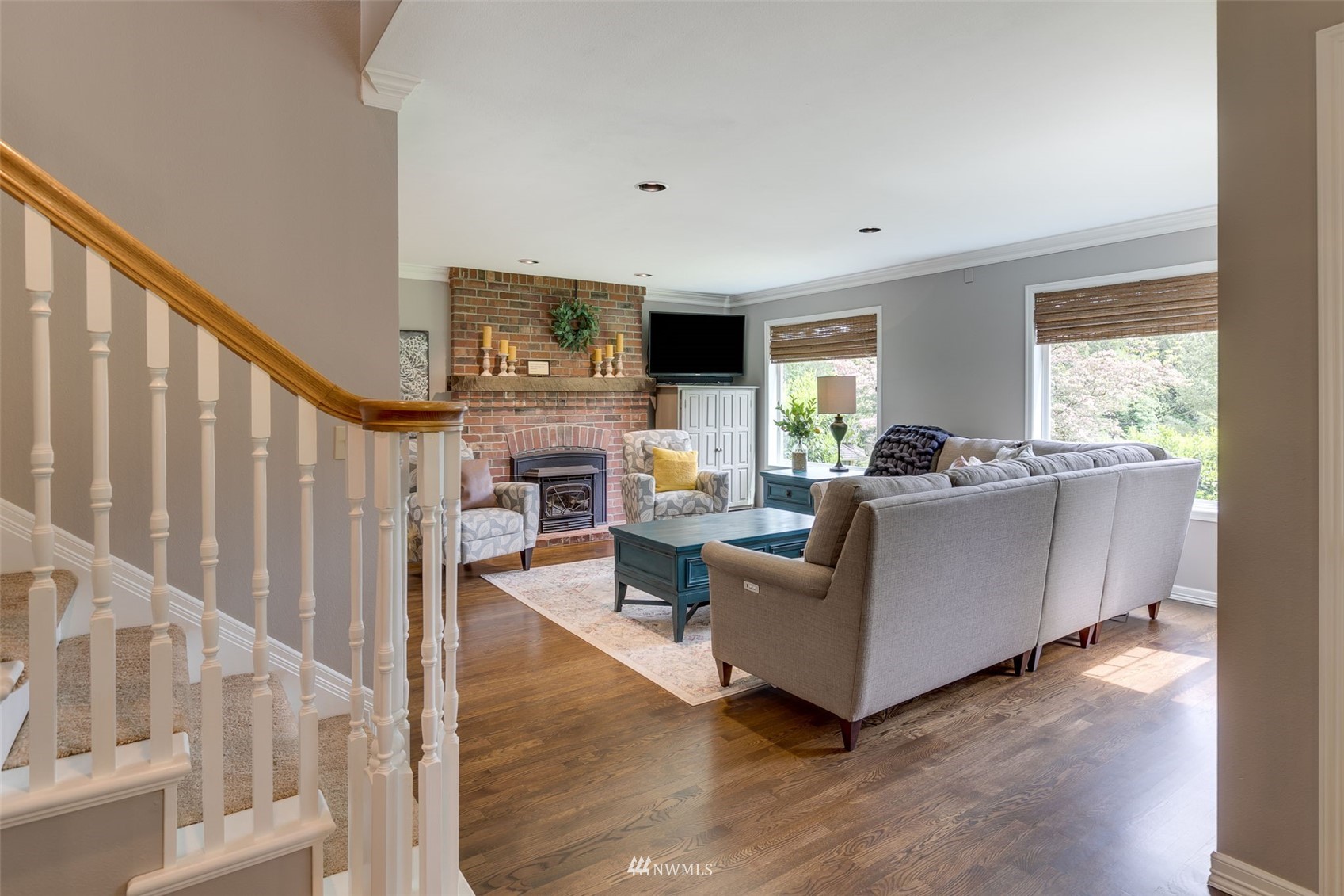 14919 Westwick Road Snohomish, WA 98290 - Photo 6 of 37 a living room with furniture a flat screen tv and a fireplace