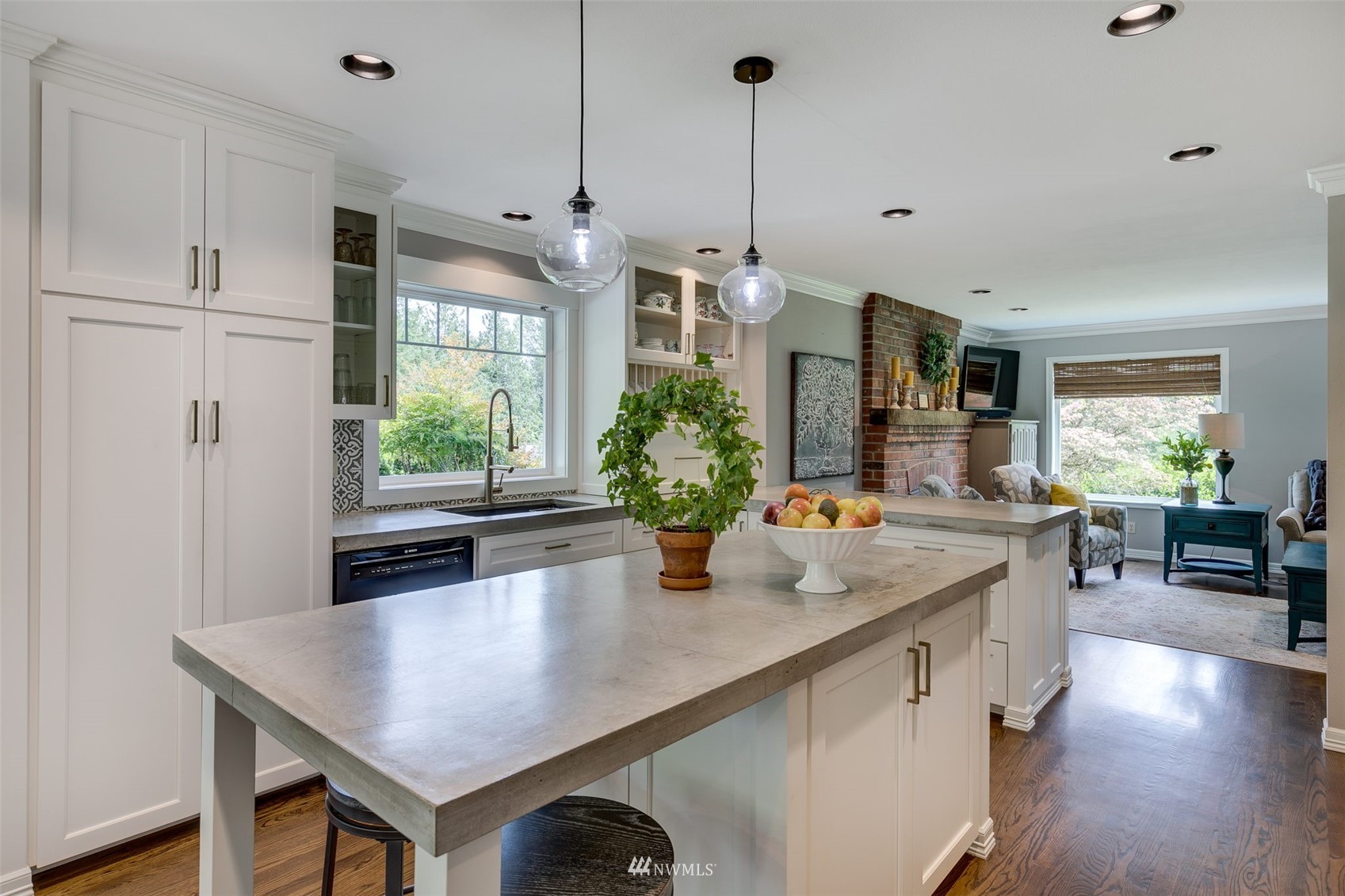 14919 Westwick Road Snohomish, WA 98290 - Photo 10 of 37 a kitchen with stainless steel appliances a table chairs and wooden floor