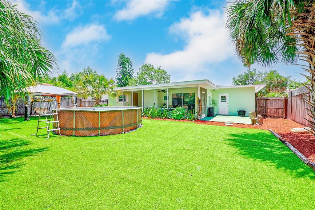 14079 Victoria Road Largo, FL 33774 - Photo 34 of 46 a view of a house with a backyard and a patio