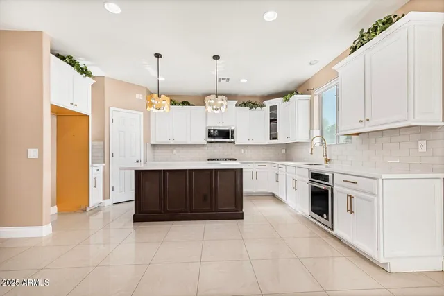 a kitchen with granite countertop white cabinets and white appliances
