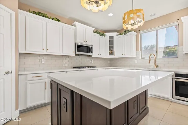 a kitchen with granite countertop white cabinets and white appliances