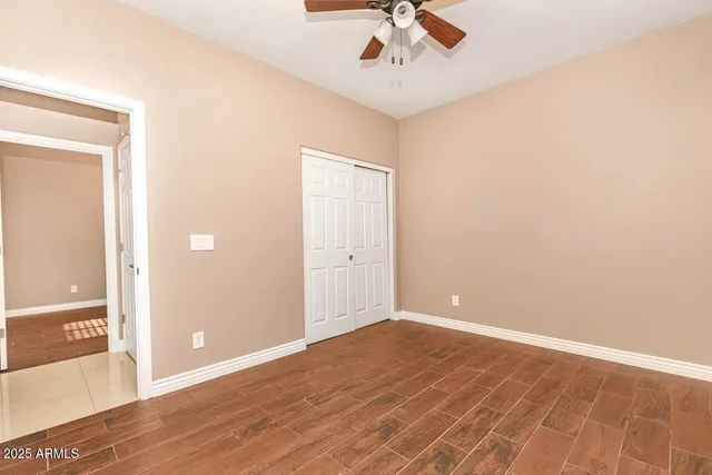 a view of a room with wooden floor and a window