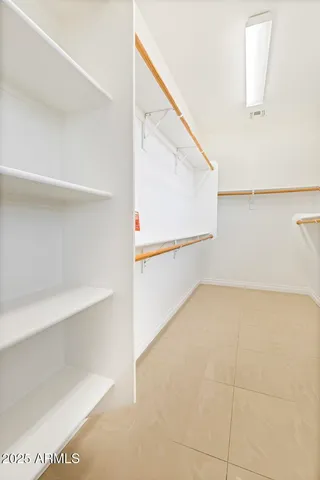 a view of a big room with closet and windows