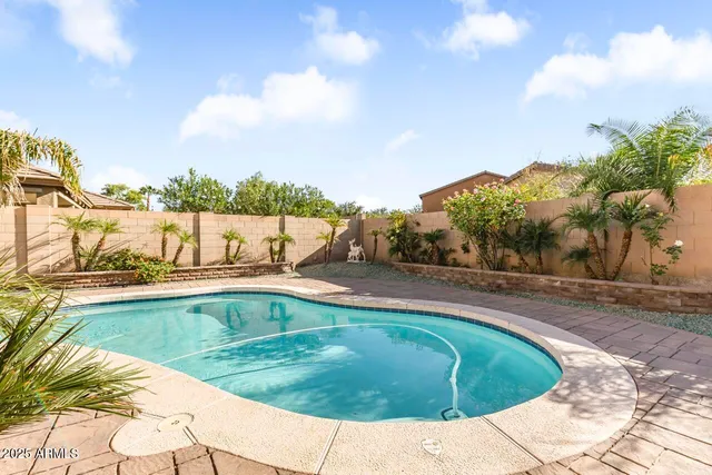a swimming pool with outdoor seating and yard