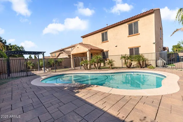 a view of a swimming pool with a yard