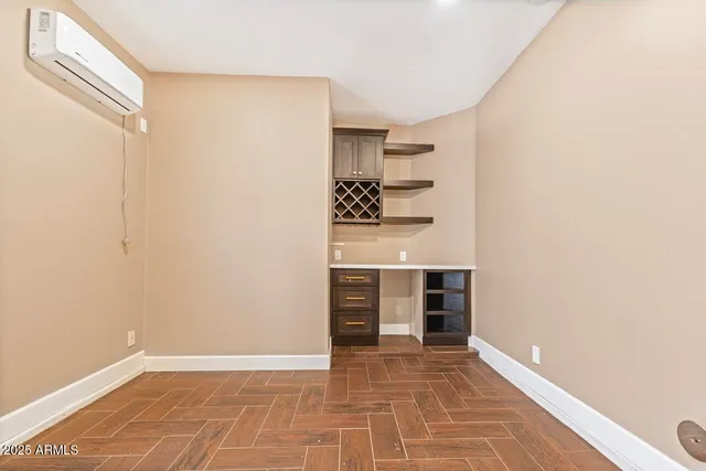 a view of an empty room with cabinet and a window