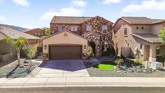 an aerial view of a house with a yard and potted plants