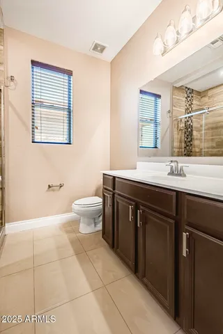a view of a livingroom with an empty space and a ceiling fan