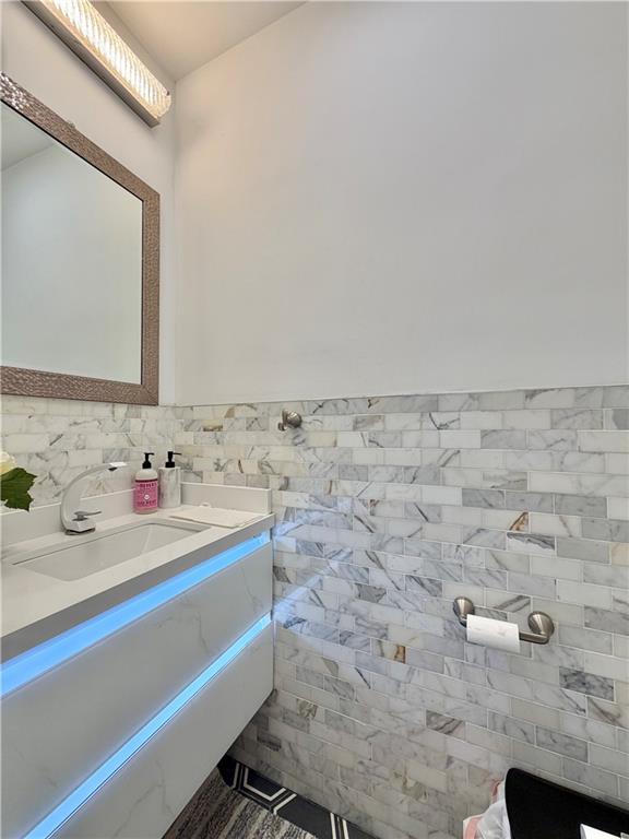 463 82nd Street Brooklyn, NY 11209 - Photo 11 of 16 a bathroom with a sink and a mirror