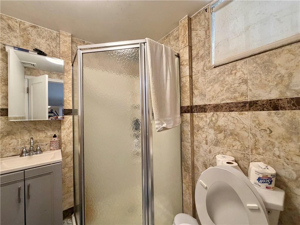 463 82nd Street Brooklyn, NY 11209 - Photo 12 of 16 a bathroom with a granite countertop sink toilet and shower