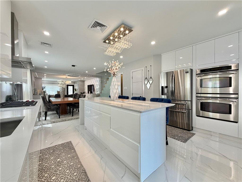 463 82nd Street Brooklyn, NY 11209 - Photo 4 of 16 a living room with stainless steel appliances furniture a rug and a kitchen view