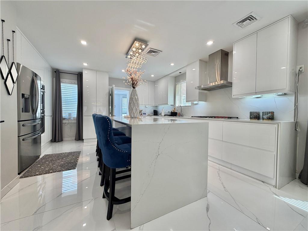 463 82nd Street Brooklyn, NY 11209 - Photo 6 of 16 a kitchen with a refrigerator a sink and cabinets