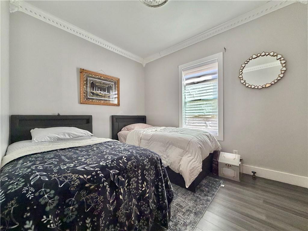 463 82nd Street Brooklyn, NY 11209 - Photo 8 of 16 a bedroom with two beds and a lamp
