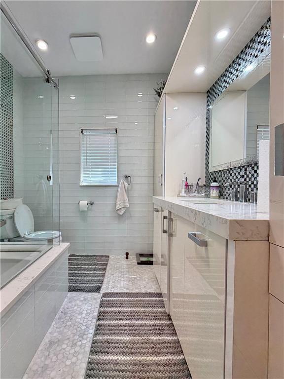 463 82nd Street Brooklyn, NY 11209 - Photo 10 of 16 a bathroom with a double vanity sink and a mirror