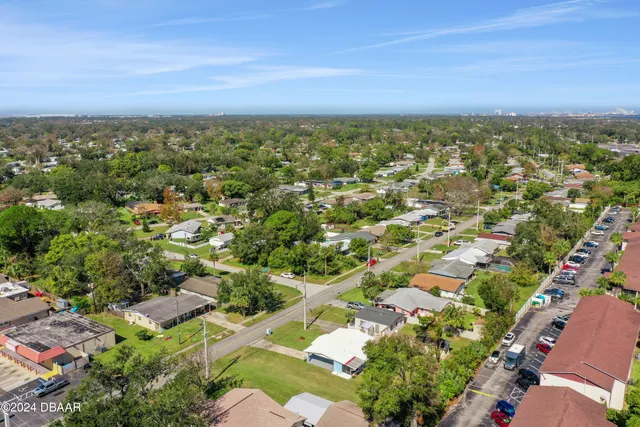 an aerial view of a houses with a yard