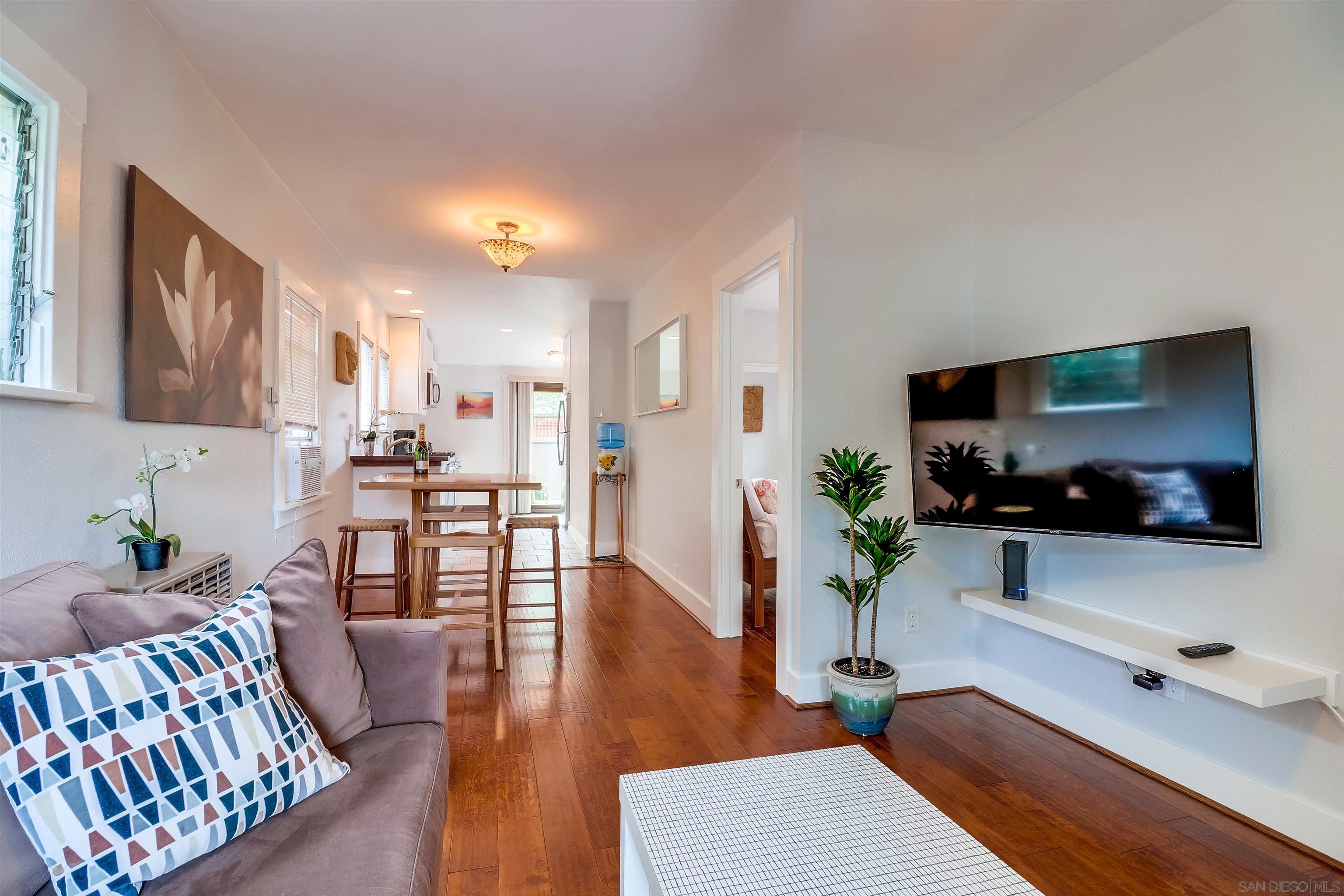 385 Nautilus Street La Jolla, CA 92037 - Photo 2 of 10 a living room with furniture fireplace and flat screen tv