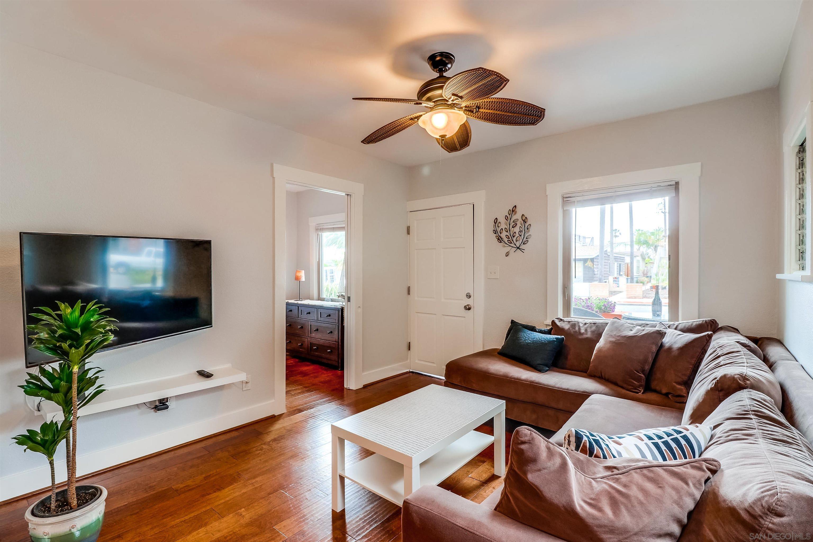 385 Nautilus Street La Jolla, CA 92037 - Photo 3 of 10 a living room with furniture and a flat screen tv