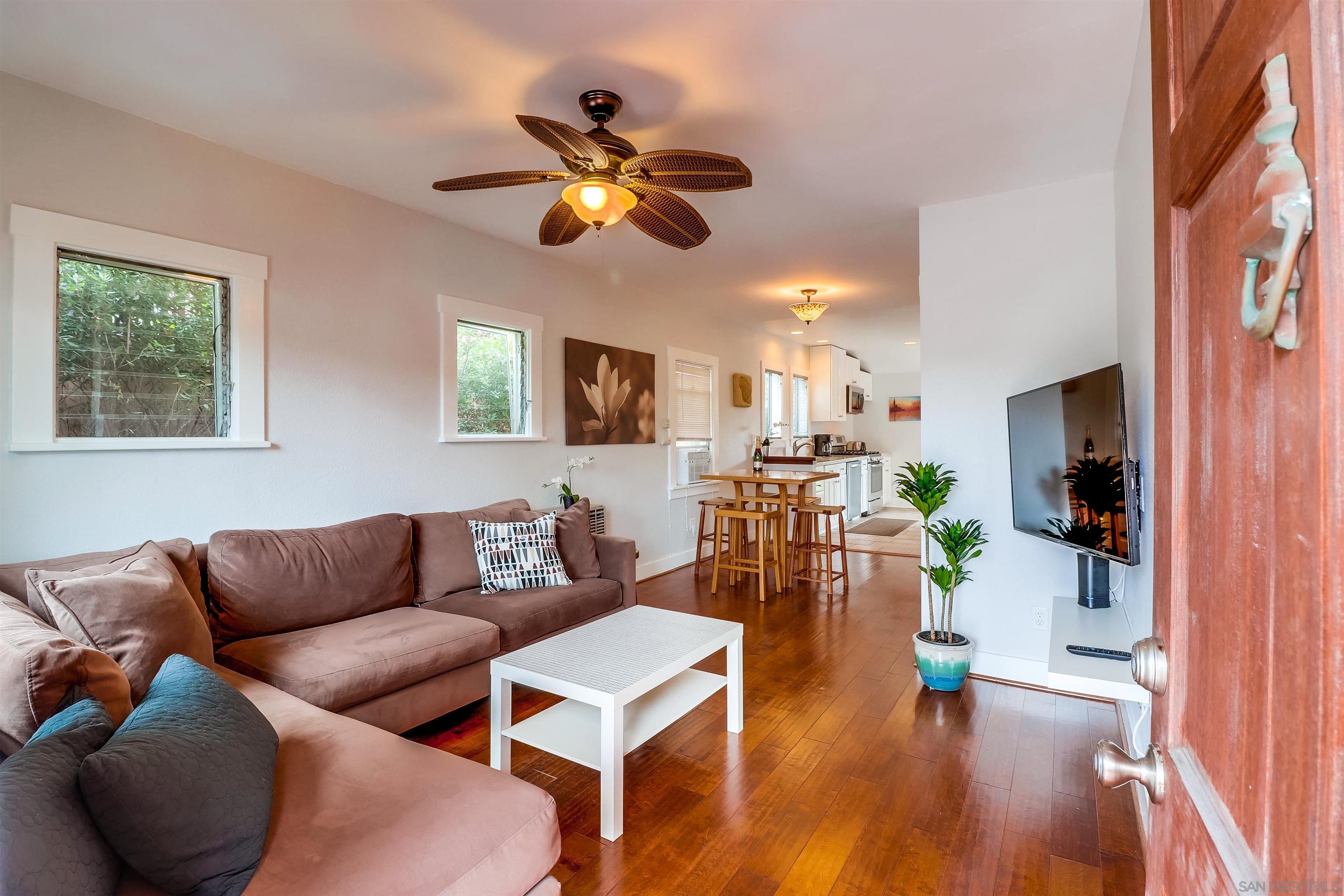385 Nautilus Street La Jolla, CA 92037 - Photo 4 of 10 a living room with furniture and a wooden floor