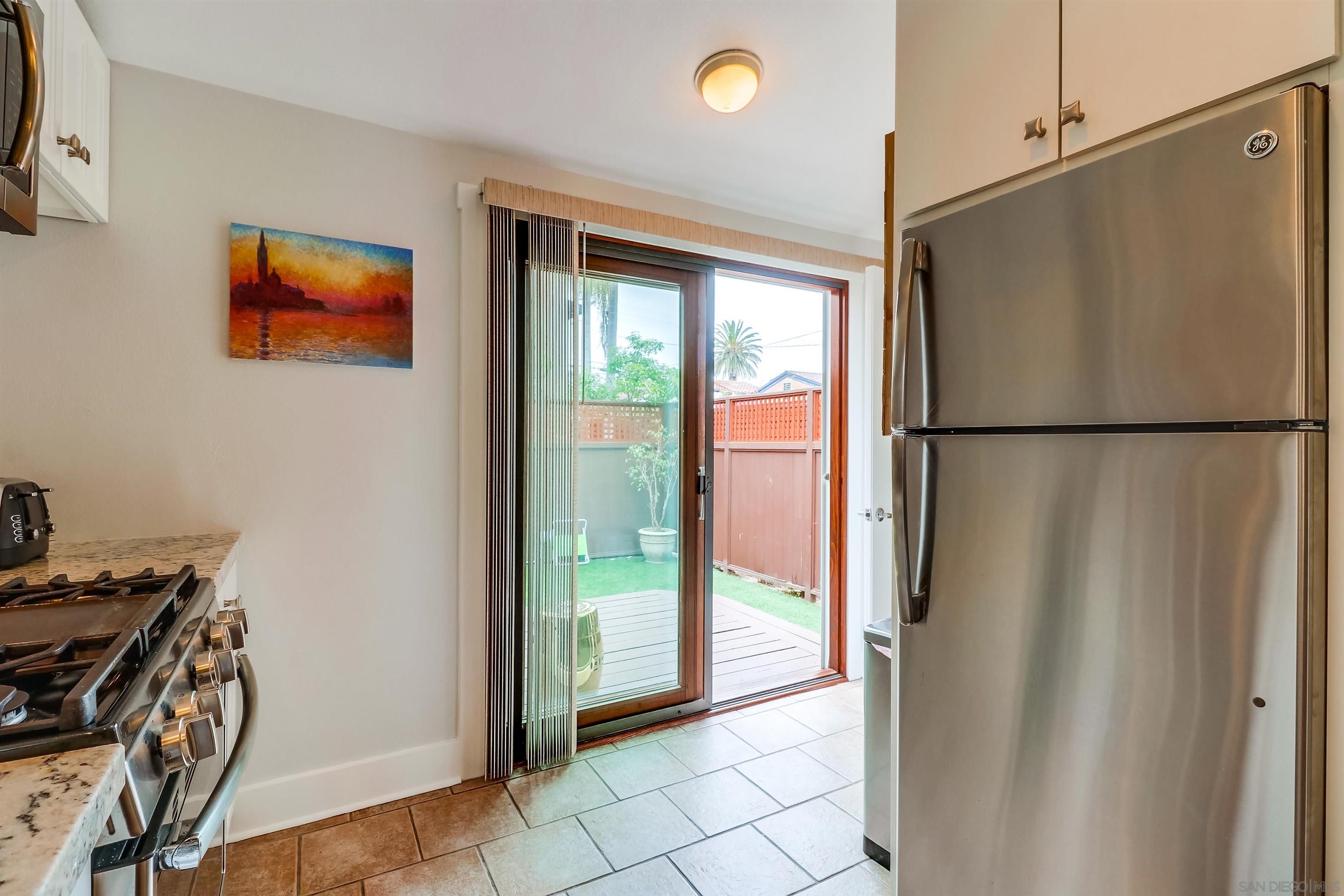 385 Nautilus Street La Jolla, CA 92037 - Photo 9 of 10 a view of a refrigerator in kitchen and an empty room