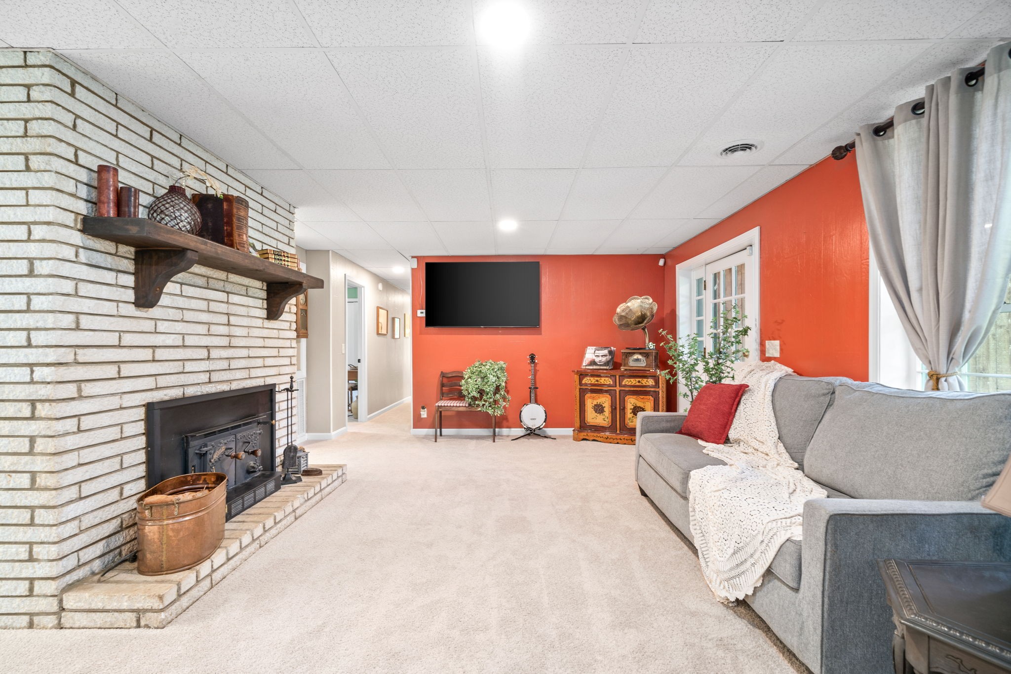 1040 Sensing Road Charlotte, TN 37036 - Photo 22 of 41 a living room with furniture a fireplace and a flat screen tv