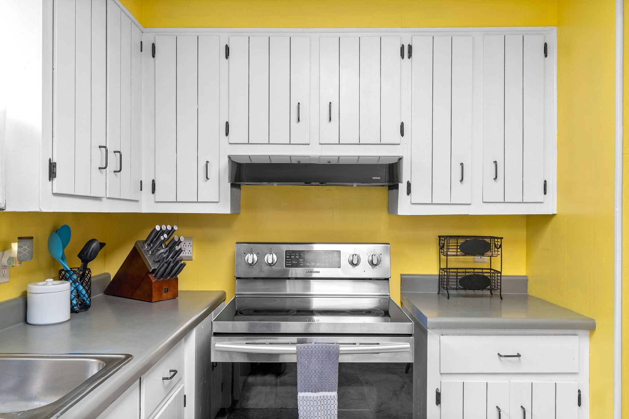 1040 Sensing Road Charlotte, TN 37036 - Photo 30 of 41 a kitchen with granite countertop white cabinets and stainless steel appliances