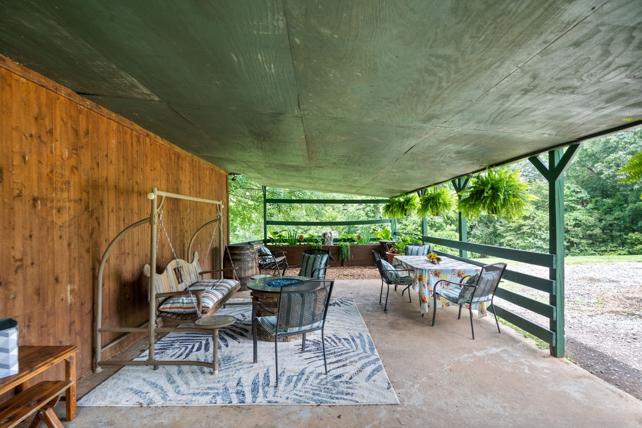1040 Sensing Road Charlotte, TN 37036 - Photo 10 of 41 a view of a patio with table and chairs and floor to ceiling window
