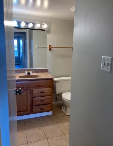 a white toilet sitting next to a bath tub