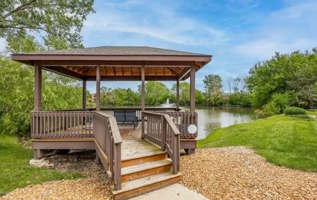 a view of a patio with a table chairs and a yard