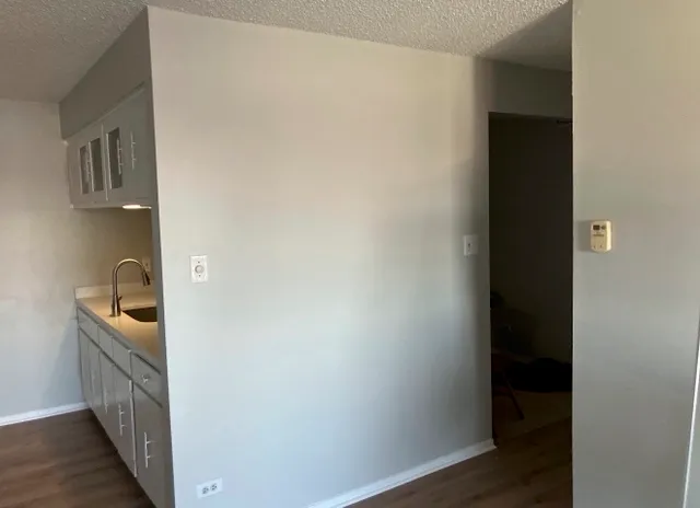 a kitchen with granite countertop cabinets and a stove top oven