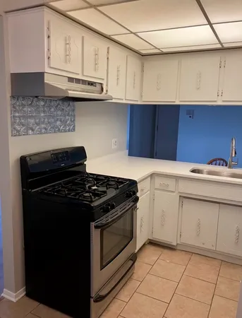 a view of cabinets and utility room with cabinets