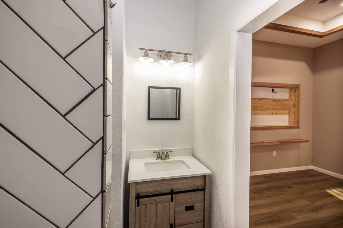304 East 9th Nordheim, TX 78141 - Photo 13 of 33 a bathroom with a sink and mirror