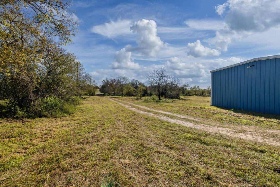 304 East 9th Nordheim, TX 78141 - Photo 31 of 33 a view of a yard with an trees