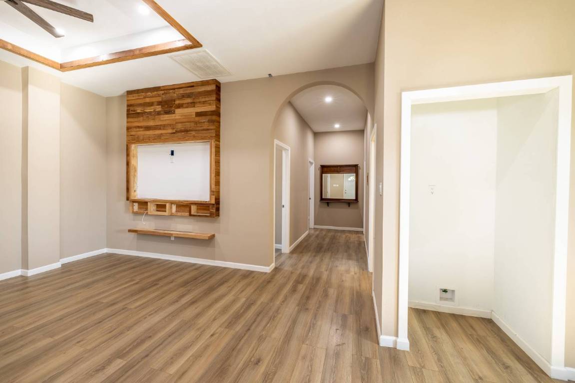304 East 9th Nordheim, TX 78141 - Photo 5 of 33 a view of a hallway with wooden floor and a bathroom