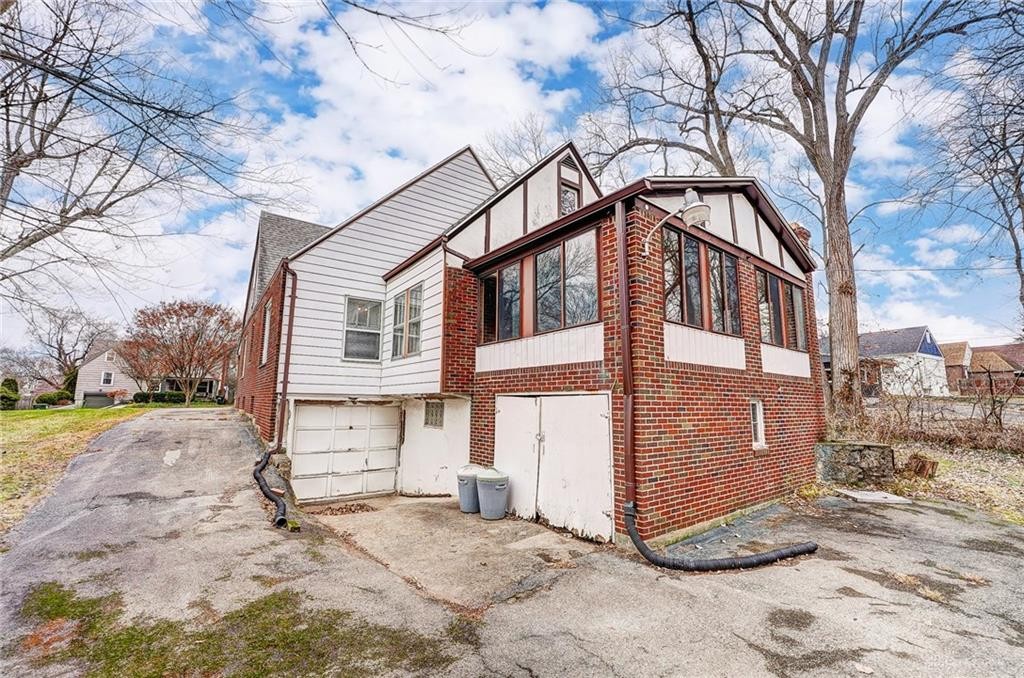 1436 Ruskin Road Dayton, OH 45406 - Photo 3 of 29 This charming home features classic brick and white siding, offering a cozy retreat with ample outdoor space.