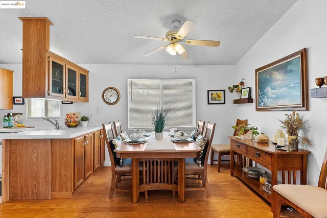a view of a dining room with furniture and chandelier