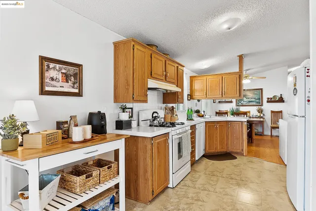 a kitchen with a stove refrigerator sink and a microwave
