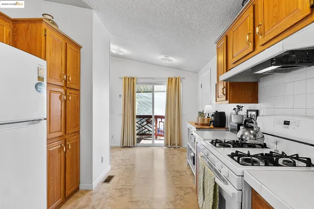 a kitchen with a stove a refrigerator and a stove