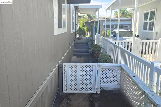 a view of a porch with wooden floor and wooden fence