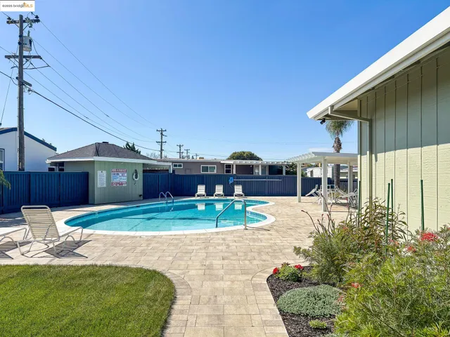a view of house with outdoor space and swimming pool