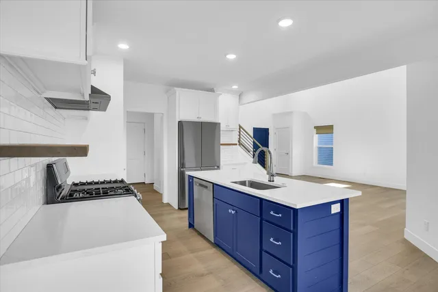 a kitchen with a sink a stove and a refrigerator
