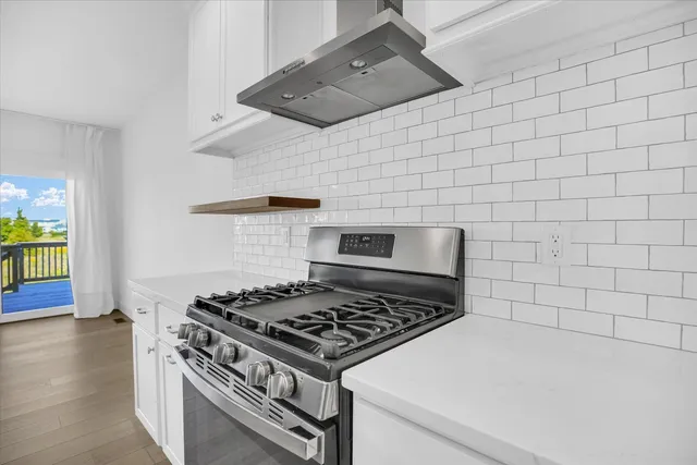 a stove top oven sitting inside of a kitchen